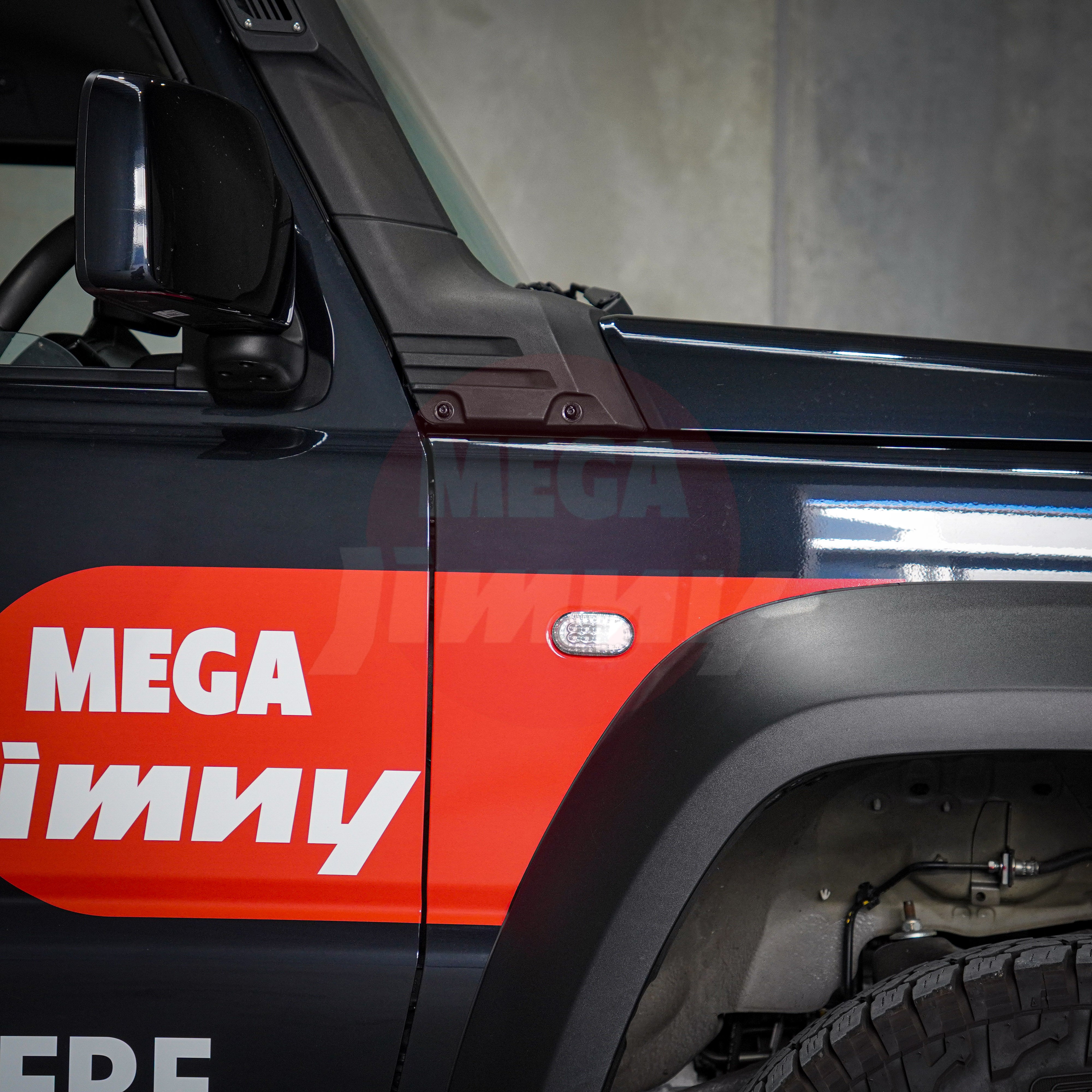 Close-up of a vehicle door with 'MEGA Jimmy' branding on a dark background