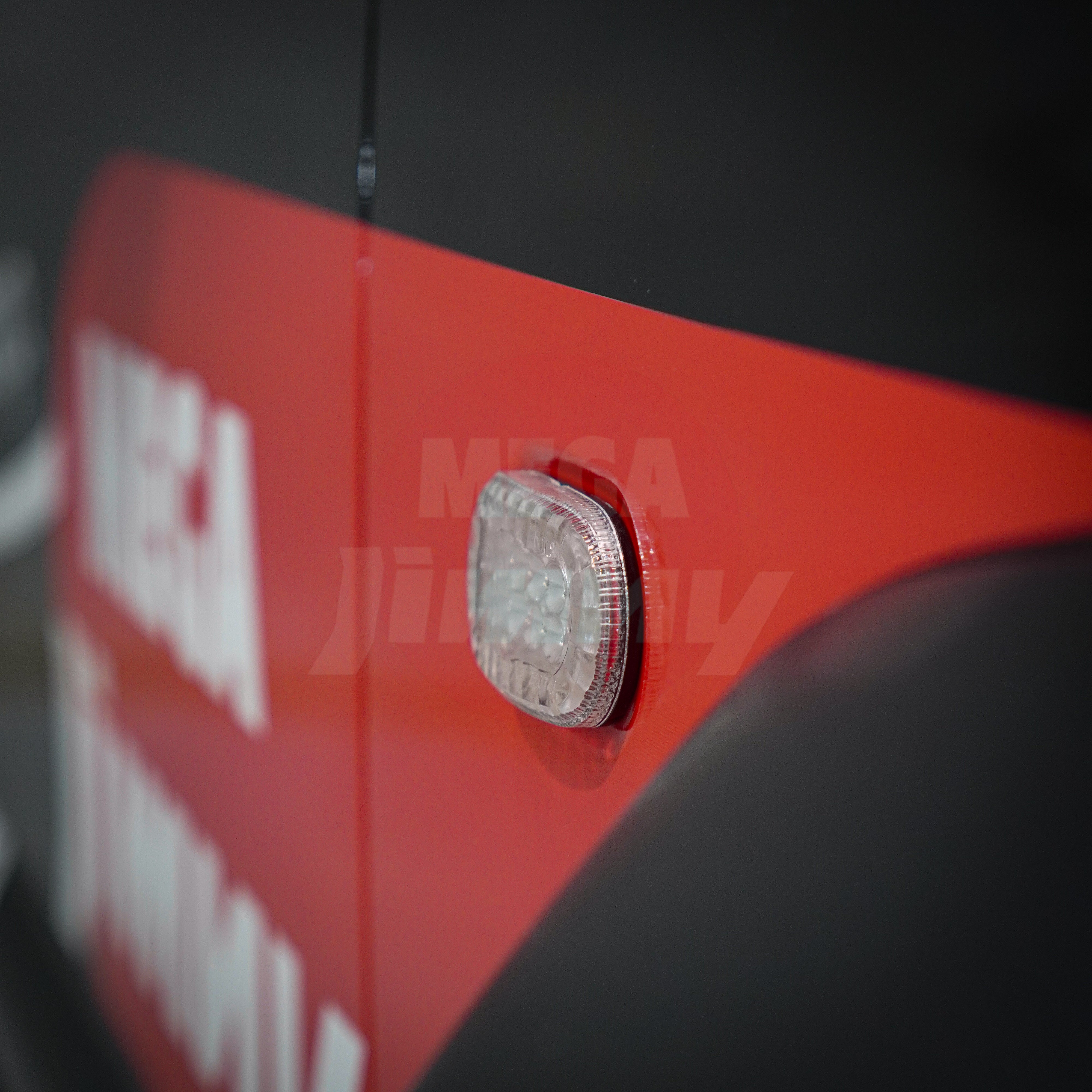Close-up of a Jimny with a clear LED light on a dark background